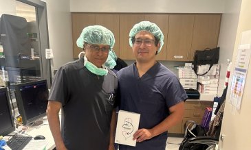 Drs Trinidad and Desai holding a Barostim sign