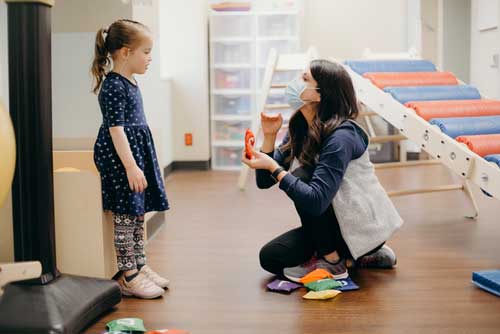 Speech therapist working with child patient